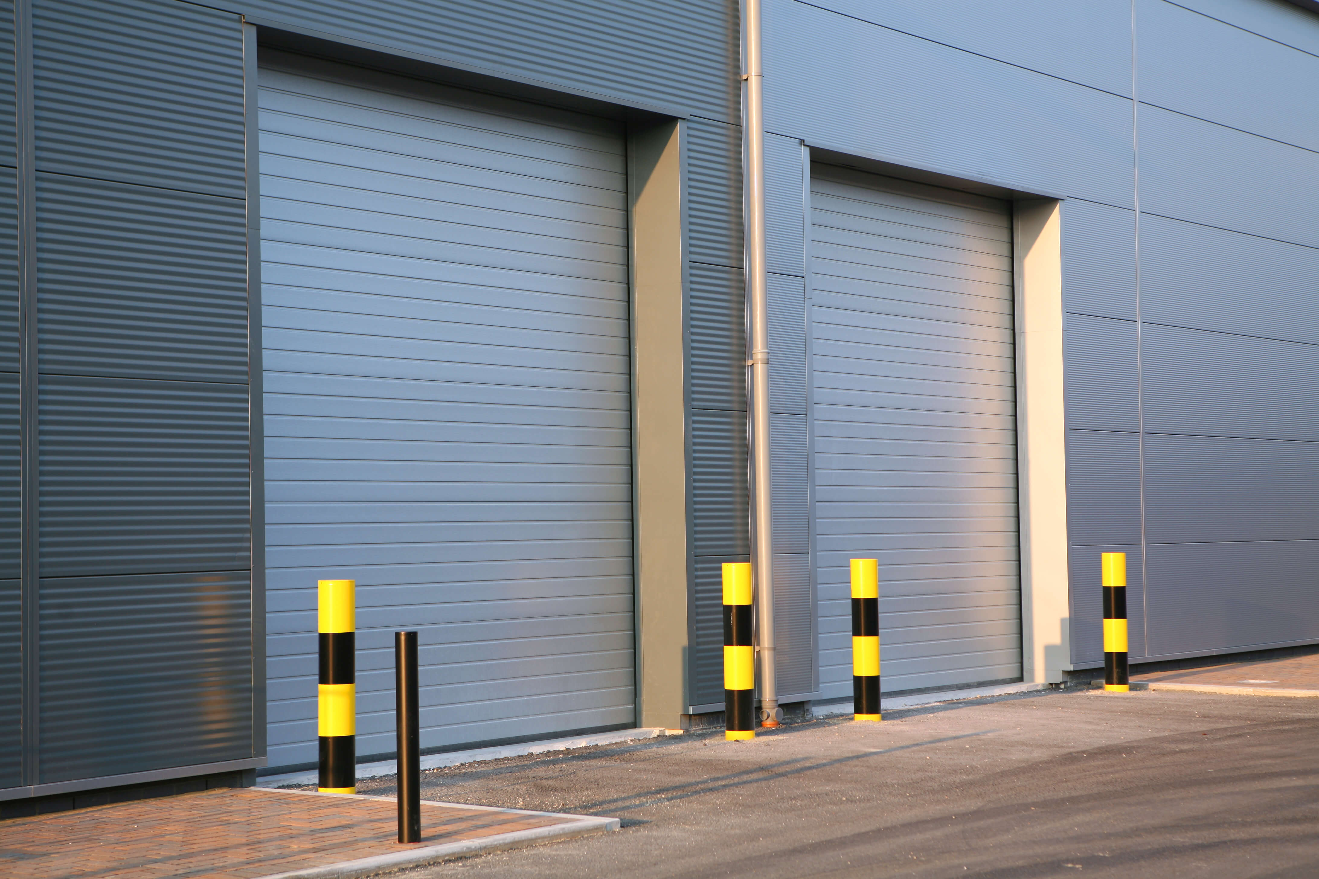 A picture of an industrial unit with garage doors closed