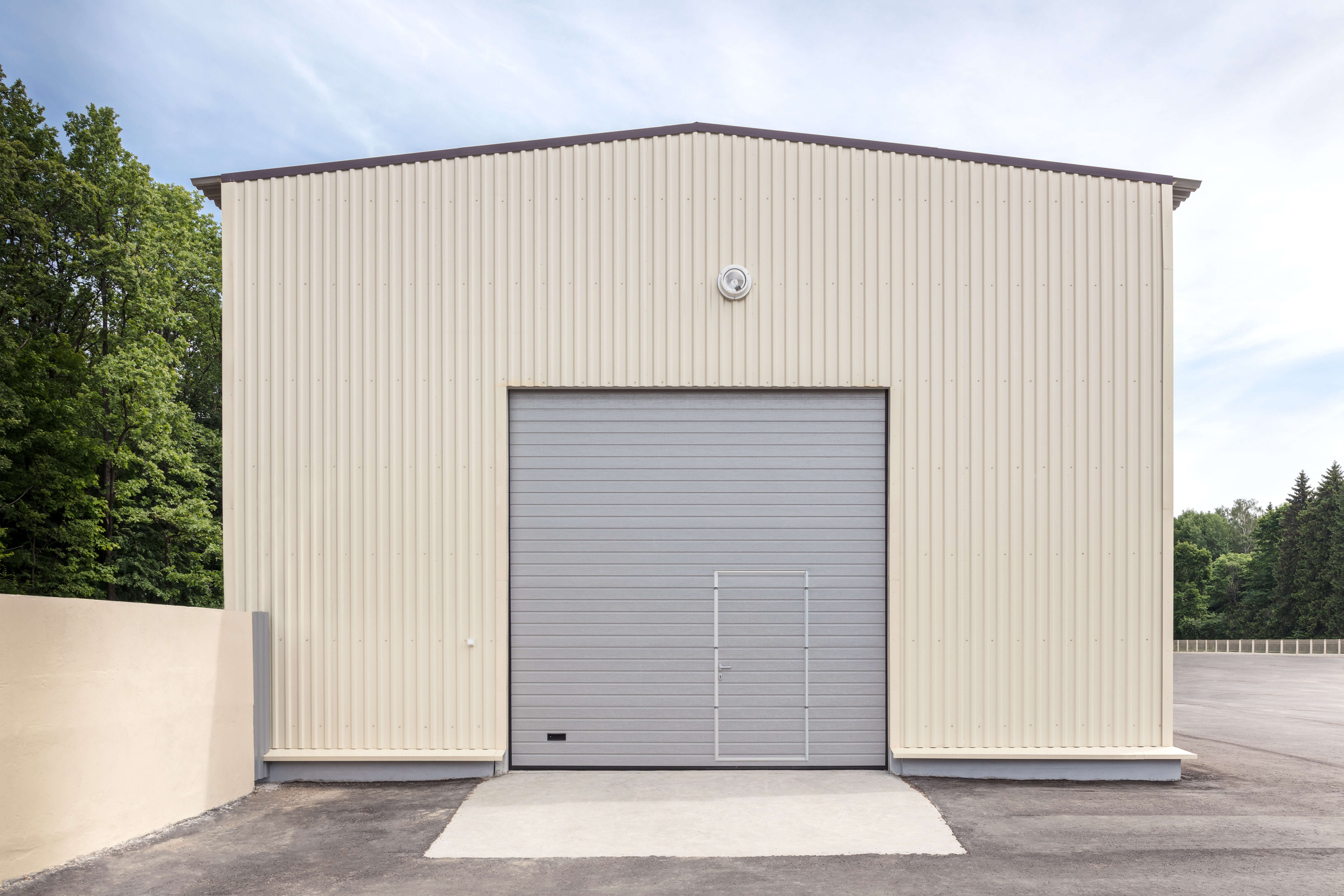 industrial storehouse with closed gray metal gate